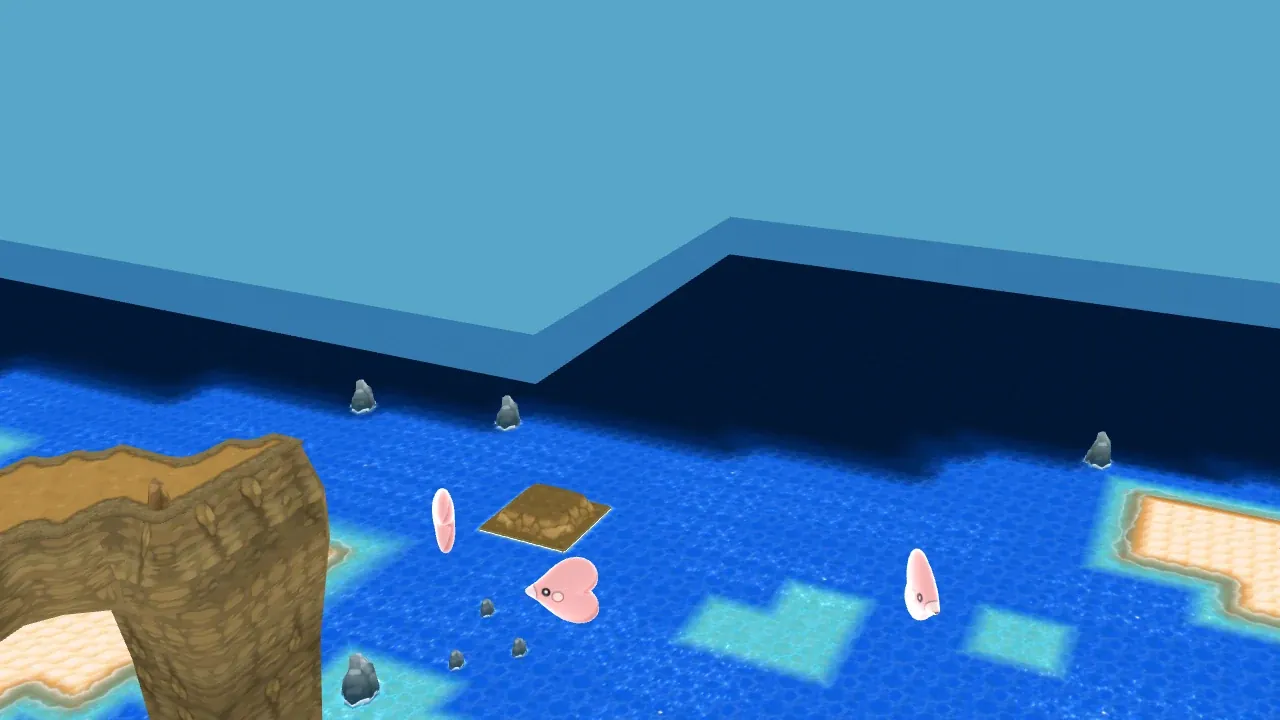 Three Luvdisc swimming in the sea off Route 8 in Pokémon X and Y, with the sandy shore and rocks behind them